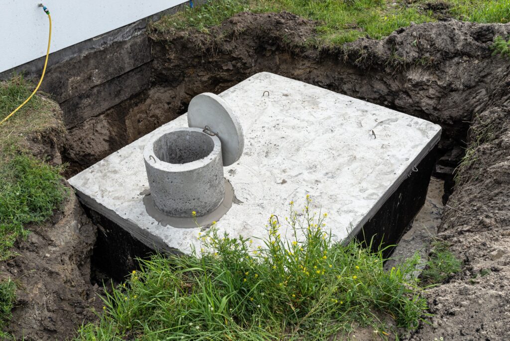 Concrete septic tank with a capacity of 10 cubic meters placed in the garden by the house.