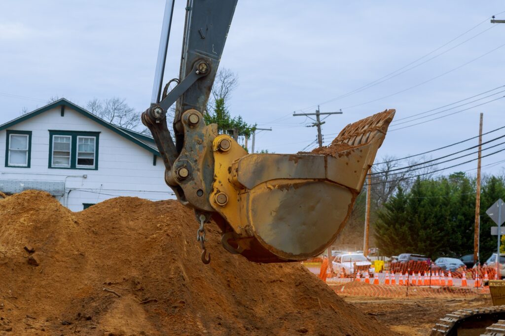 Houses under construction foundation with excavator shovel a septic tank sewerage construction