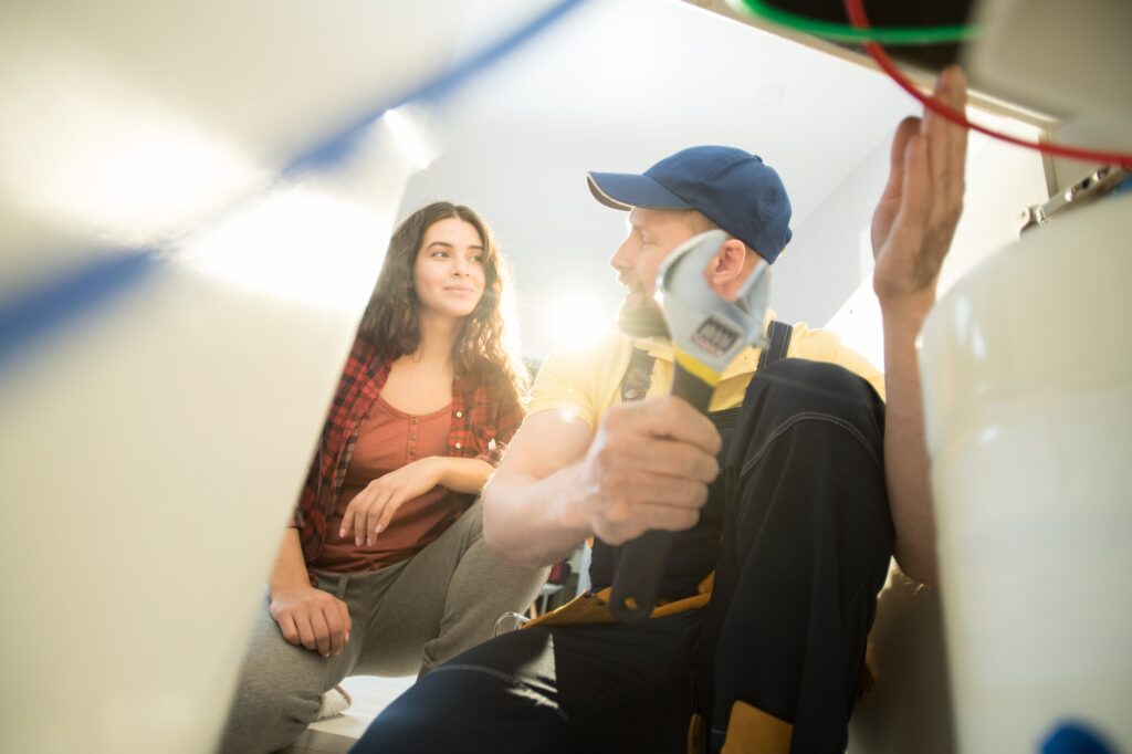 Plumber explaining reason of clogged drains