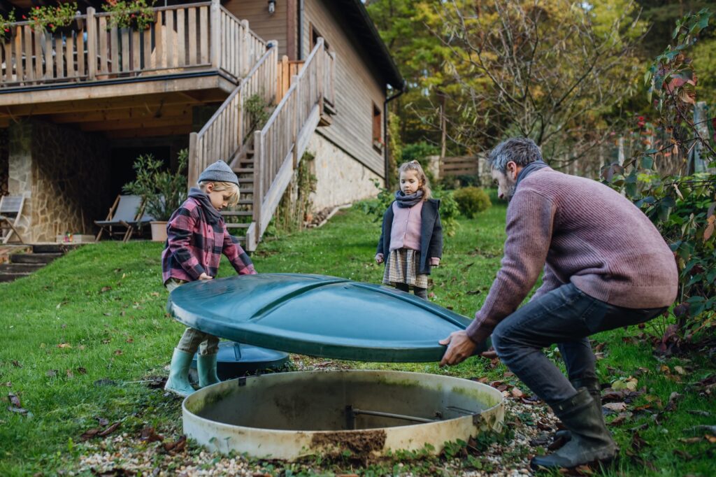 The family checks the water quality in the home wastewater treatment system. Concept of sustainable