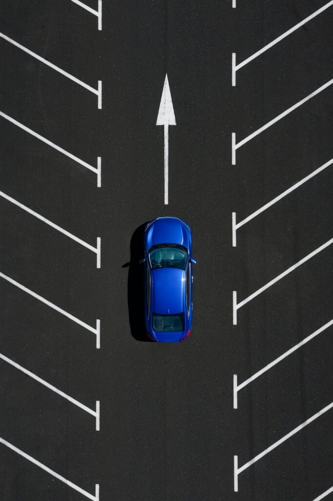 Transportation. View on the car from the air. Car in an empty parking lot.