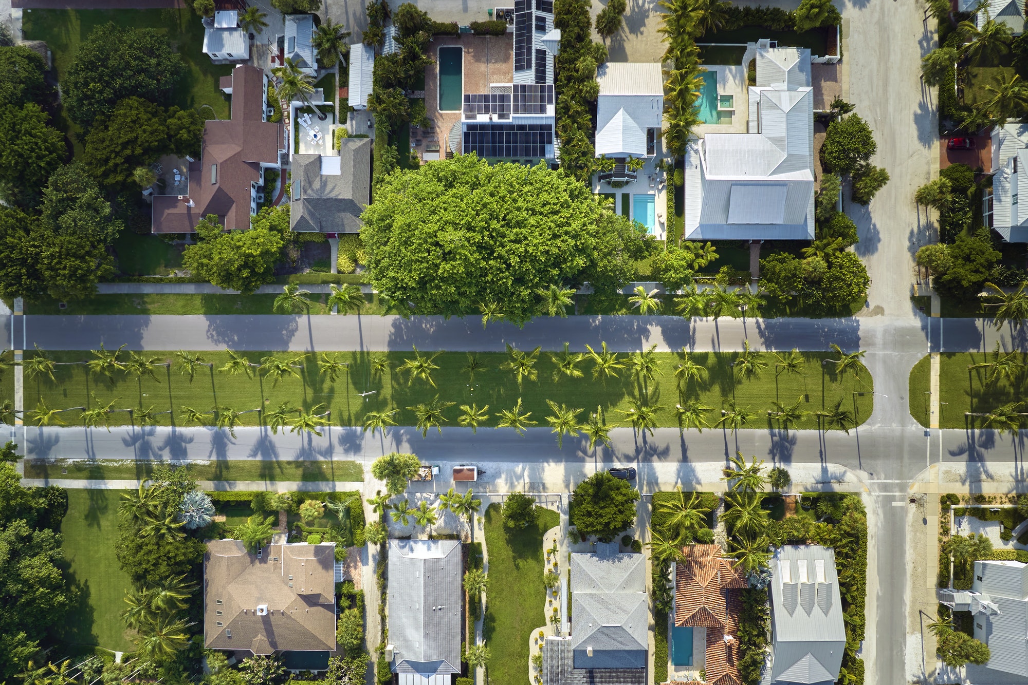 View from above of large residential houses in closed living golf club in south Florida.