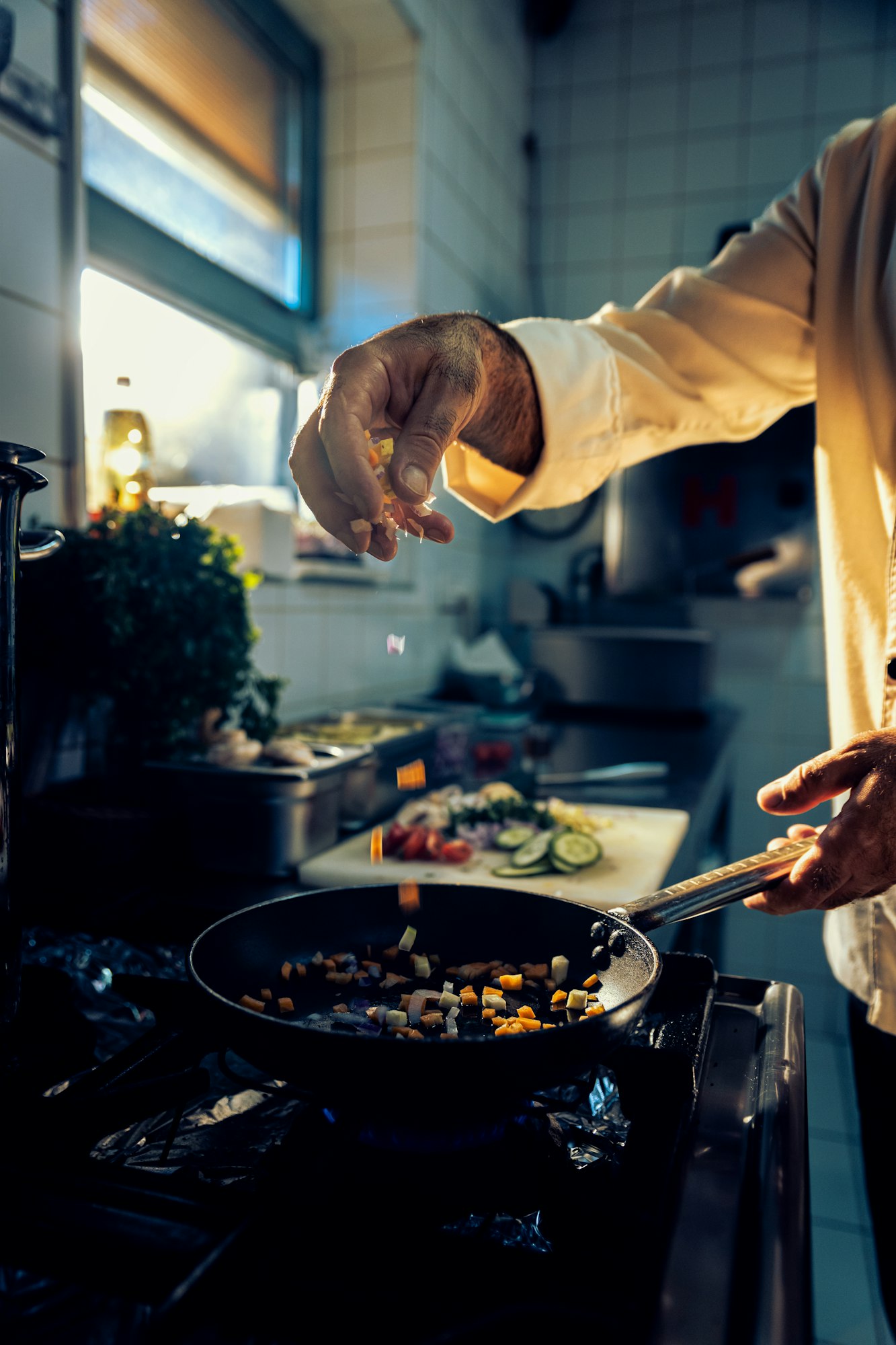 Chef cooking in a commercial kitchen.